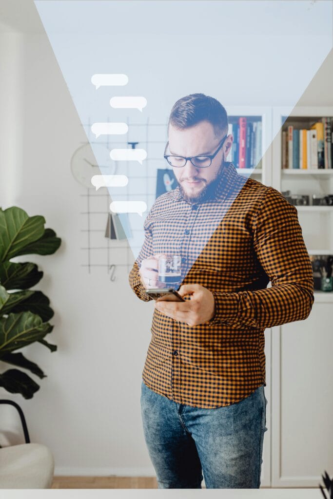 pexels-photo-6214835-6214835 A man in casual attire using a smartphone, standing in a modern home office with overlay graphics.